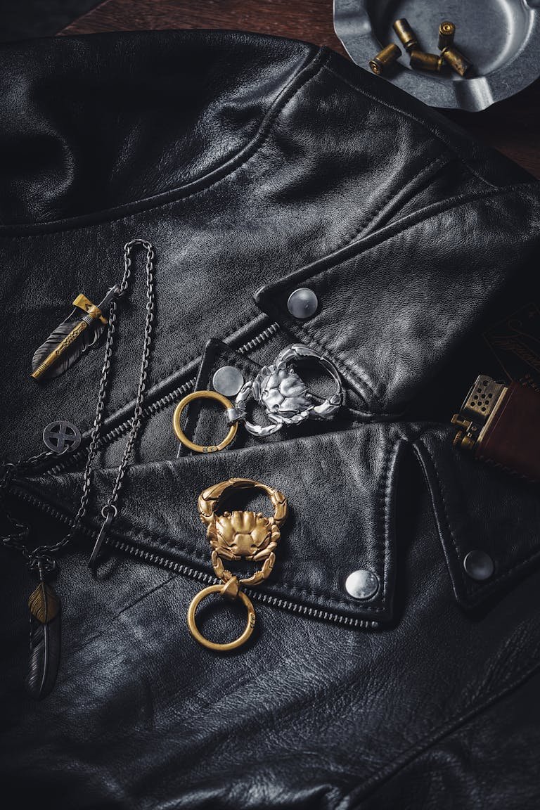 Stylish leather jacket featuring detailed crab key rings and jewelry accessories.